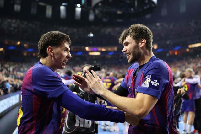 FC Barcelona's Spanish left wing #83 Ian Barrufet and FC Barcelona's Bosnian-born right back #11 Djordje Cikusa celebrate after winning the EHF Men's Handball Champions League Final 4 final between Barca and Fuechse Berlin in Cologne, western Germany on June 14, 2026. Barca won the match 37:34. (Photo by Ronny HARTMANN / AFP)