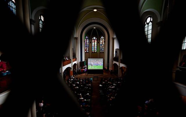 German fans attend the public screening of Germany's opening match at the 2026 World Cup against Curacao, as pianist Stephan von Bothmer accompanies the match on the organ at the Twelve Apostles Evangelical Church in Berlin on June 14, 2026. (Photo by Tobias SCHWARZ / AFP)