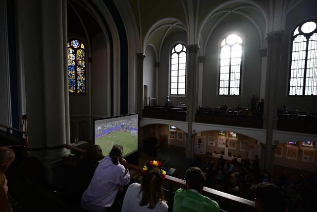 German fans attend the public screening of Germany's opening match at the 2026 World Cup against Curacao, as pianist Stephan von Bothmer accompanies the match on the organ at the Twelve Apostles Evangelical Church in Berlin on June 14, 2026. (Photo by Tobias SCHWARZ / AFP)