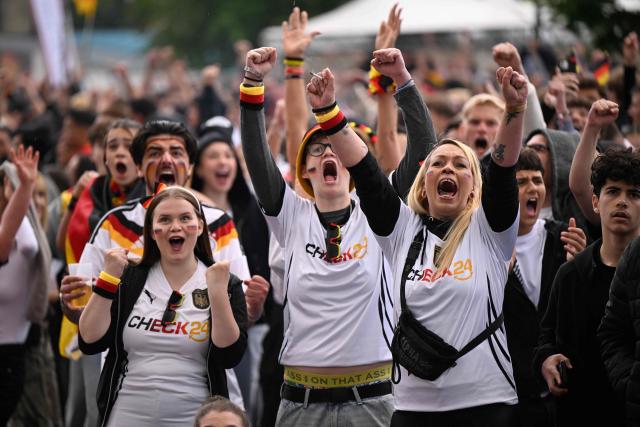 Germany fans celebrate after the 4-1 goal the public screening of Germany's opening match at the 2026 World Cup against Curacao at the former coal mine 'Ewald' in Herten, western Germany on June 14, 2026. (Photo by INA FASSBENDER / AFP)