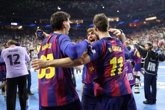 Barca players celebrate after winning the EHF Men's Handball Champions League Final 4 final between Barca and Fuechse Berlin in Cologne, western Germany on June 14, 2026. Barca won the match 37:34. (Photo by Ronny HARTMANN / AFP)