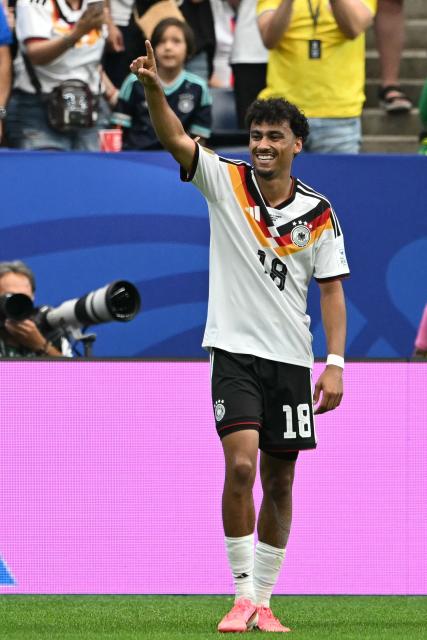 Germany's defender #18 Nathaniel Brown   celebrates   after scoring his team's fifth goal during the 2026 World Cup Group E football match between Germany and Curacao at the Houston Stadium in Houston on June 14, 2026.  (Photo by RONALDO SCHEMIDT / AFP)