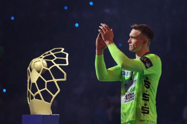 Fuechse Berlin's Danish left back Lasse Andersson applauds as he walks past the trophy after the EHF Men's Handball Champions League Final 4 final between Barca and Fuechse Berlin in Cologne, western Germany on June 14, 2026. Barca won the match 37:34. (Photo by Ronny HARTMANN / AFP)
