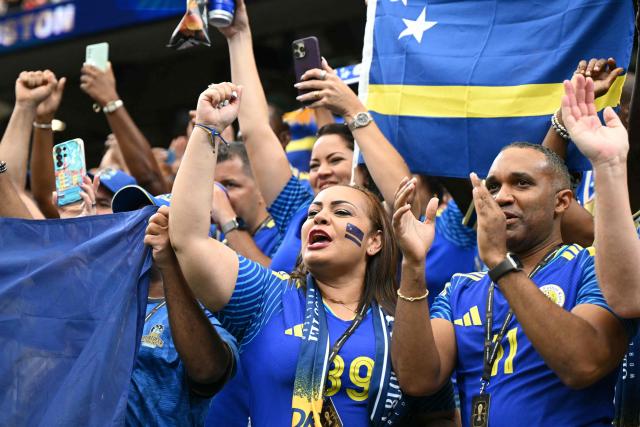 Curacao supporters react after the  2026 World Cup Group E football match between Germany and Curacao at the Houston Stadium in Houston on June 14, 2026.  (Photo by RONALDO SCHEMIDT / AFP)