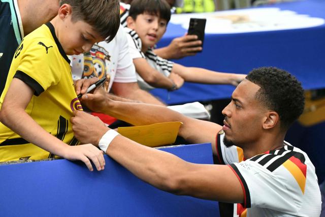 Germany's defender #23 Felix Nmecha signs a fan's shirt after the 2026 World Cup Group E football match between Germany and Curacao at the Houston Stadium in Houston on June 14, 2026.  (Photo by RONALDO SCHEMIDT / AFP)