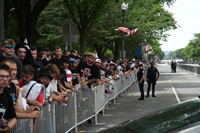 Fans gather in downtown Washington, DC, ahead of the "UFC Freedom 250" mixed martial arts event being held tonight on the South Lawn of the White House in Washington, DC, June 14, 2026. (Photo by Alex WROBLEWSKI / AFP)
