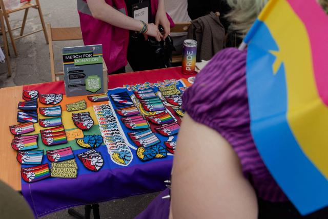This photo shows patches featuring a unicorn representing LGBT service members on sale during Kyiv Pride Park, a charity and educational event that traditionally opens the capital's Pride on the eve of the Equality March, in Kyiv on June 14, 2026, amid the Russian invasion of Ukraine. (Photo by Tetiana DZHAFAROVA / AFP)