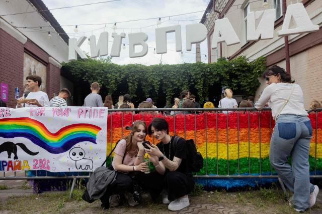 People gather during Kyiv Pride Park, a charity and educational event that traditionally opens the capital's Pride on the eve of the Equality March, in Kyiv on June 14, 2026, amid the Russian invasion of Ukraine. (Photo by Tetiana DZHAFAROVA / AFP)