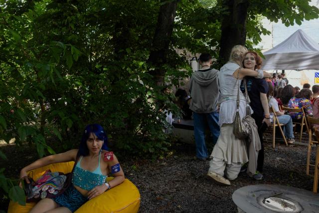 People gather during Kyiv Pride Park, a charity and educational event that traditionally opens the capital's Pride on the eve of the Equality March, in Kyiv on June 14, 2026, amid the Russian invasion of Ukraine. (Photo by Tetiana DZHAFAROVA / AFP)