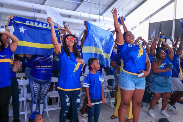 Supporters of Curacao cheer for their team as they watch the transmission of the FIFA World Cup match Germany vs Curacao in Willemstad, Curacao, on June 14, 2026. (Photo by Pong Pong / AFP)