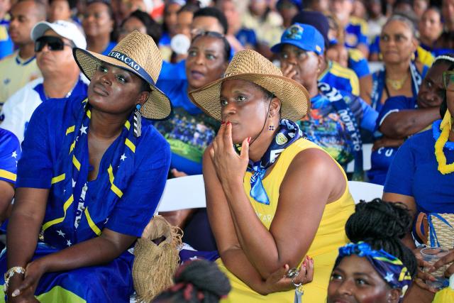 Supporters of Curacao cheer for their team as they watch the transmission of the FIFA World Cup match Germany vs Curacao in Willemstad, Curacao, on June 14, 2026. (Photo by Pong Pong / AFP)