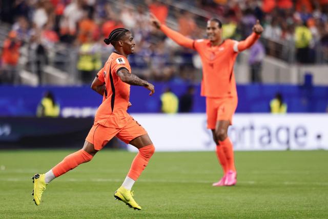 Netherlands' forward #24 Crysencio Summerville (L) celebrates after scoring his team's second goal during the 2026 World Cup Group F football match between the Netherlands and Japan at the Dallas Stadium in Arlington on June 14, 2026.  (Photo by Aric Becker / AFP)