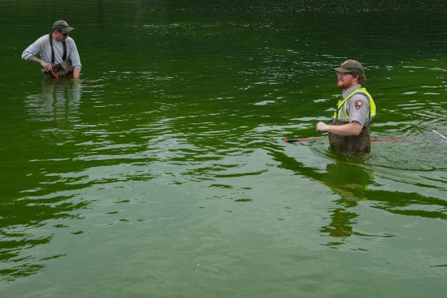 National Park Service workers push algae towards an aeration area in the center of the Lincoln Memorial Reflecting Pool following the completion of recent renovations in Washington, DC, on June 14, 2026. The reflecting pool project, undertaken as part of President Donald Trump’s preparations for the nation’s 250th anniversary, began in April and was completed last week. (Photo by Ken CEDENO / AFP)