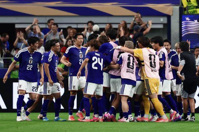 Japan's players celebrate their second goal during the 2026 World Cup Group F football match between the Netherlands and Japan at the Dallas Stadium in Arlington on June 14, 2026.  (Photo by Aric Becker / AFP)