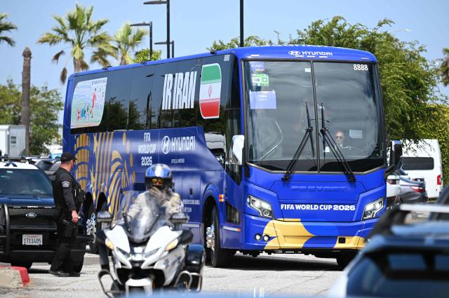 the bus carrying the Iran's national football team leaves Los Angeles International Airport on June 14, 2026, on the eve of the 2026 World Cup football match between Iran and New Zealand.  (Photo by Patrick T. Fallon / AFP)