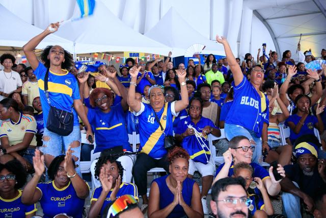 Supporters of Curacao cheer for their team as they watch the transmission of the FIFA World Cup match Germany vs Curacao in Willemstad, Curacao, on June 14, 2026. (Photo by Pong Pong / AFP)