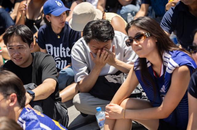 Japan supporters react as the Netherlands score their second goal during the second half of the 2026 FIFA World Cup match between Japan and the Netherlands at a watch party in the Little Tokyo neighborhood of Los Angeles on June 14, 2026. (Photo by ETIENNE LAURENT / AFP)