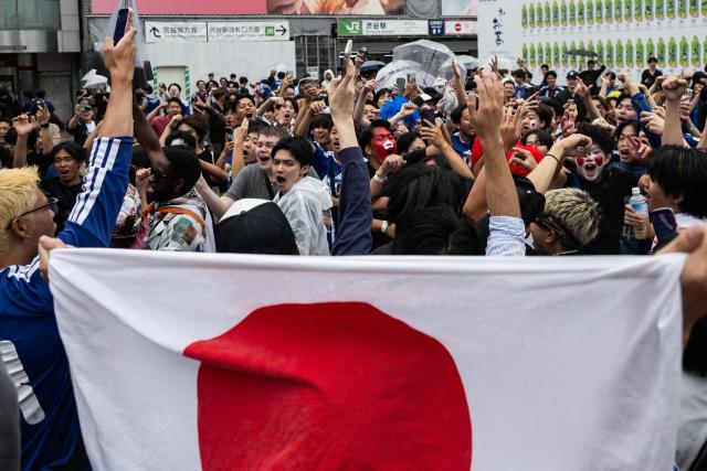 Fans celebrate early in the morning at Shibuya Crossing in Tokyo on June 15, 2026, after Japan’s 2–2 draw with the Netherlands in the 2026 World Cup. (Photo by Andrew CABALLERO-REYNOLDS / AFP)
