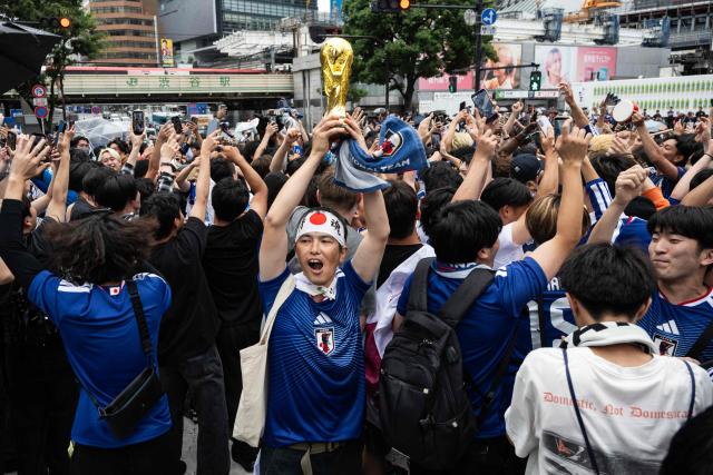 Fans celebrate early in the morning at Shibuya Crossing in Tokyo on June 15, 2026, after Japan’s 2–2 draw with the Netherlands in the 2026 World Cup. (Photo by Andrew CABALLERO-REYNOLDS / AFP)