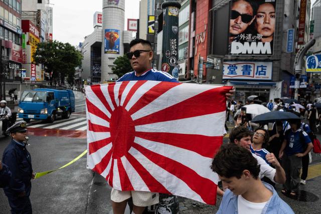 Fans celebrate early in the morning at Shibuya crossing in Tokyo on June 15, 2026, after Japans 2-2 draw with the Netherlands in the World Cup. (Photo by Andrew CABALLERO-REYNOLDS / AFP)