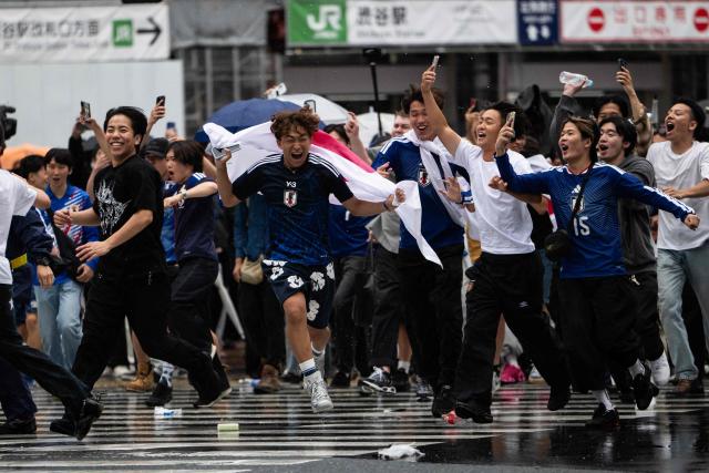 Fans celebrate early in the morning at Shibuya crossing in Tokyo on June 15, 2026, after Japans 2-2 draw with the Netherlands in the World Cup. (Photo by Andrew CABALLERO-REYNOLDS / AFP)