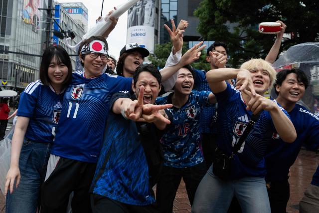 Fans celebrate early in the morning at Shibuya Crossing in Tokyo on June 15, 2026, after Japan’s 2–2 draw with the Netherlands in the 2026 World Cup. (Photo by Andrew CABALLERO-REYNOLDS / AFP)