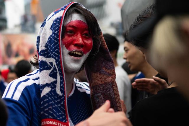 Fans celebrate early in the morning at Shibuya Crossing in Tokyo on June 15, 2026, after Japan’s 2–2 draw with the Netherlands in the 2026 World Cup. (Photo by Andrew CABALLERO-REYNOLDS / AFP)