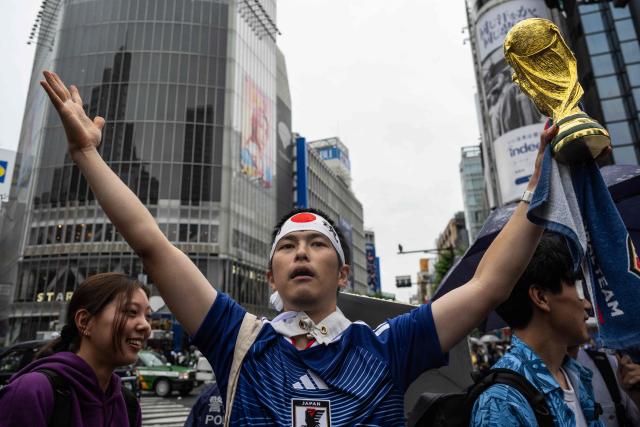 Fans celebrate early in the morning at Shibuya Crossing in Tokyo on June 15, 2026, after Japan’s 2–2 draw with the Netherlands in the 2026 World Cup. (Photo by Andrew CABALLERO-REYNOLDS / AFP)