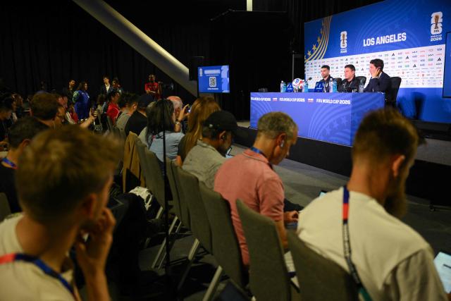 Iran's head coach Amir Ghalenoei (C) gives a press conference next to Iran’s forward #09 Mehdi Taremi (L) at Los Angeles Stadium in Inglewood on June 14, 2026, on the eve of the 2026 World Cup football match between Iran and New Zealand. (Photo by Patrick T. FALLON / AFP)