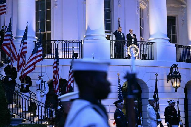 US President Donald Trump and President and CEO of Ultimate Fighting Championship Dana White listen to the National Anthem from the Blue Room Balcony ahead of the "UFC Freedom 250" mixed martial arts event on the South Lawn of the White House in Washington, DC, June 14, 2026. (Photo by Brendan SMIALOWSKI / AFP)
