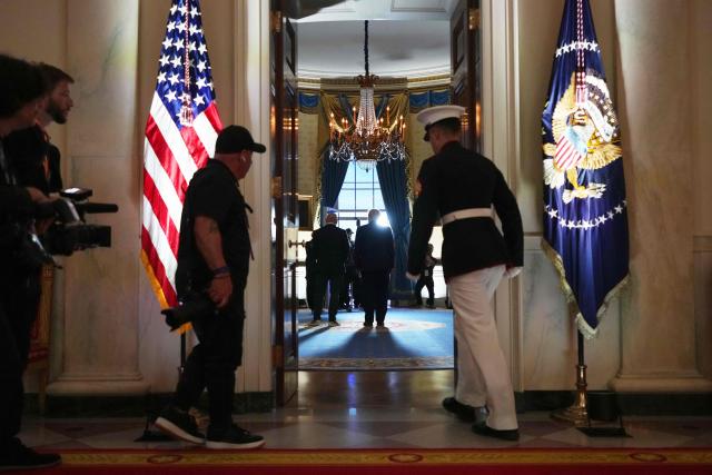 US President Donald Trump walks with UFC president and CEO Dana White through the Cross Hall of the White House before attending the UFC Freedom 250 fights on the South Lawn of the White House, in Washington, DC, on June 14, 2026. (Photo by Jacquelyn Martin / POOL / AFP)