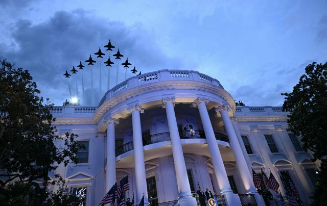Aircrafts fly in formation over the White House as US President Donald Trump and President and CEO of Ultimate Fighting Championship Dana White listen to the National Anthem from the Blue Room Balcony ahead of the "UFC Freedom 250" mixed martial arts event on the South Lawn of the White House in Washington, DC, June 14, 2026. (Photo by Brendan SMIALOWSKI / AFP)