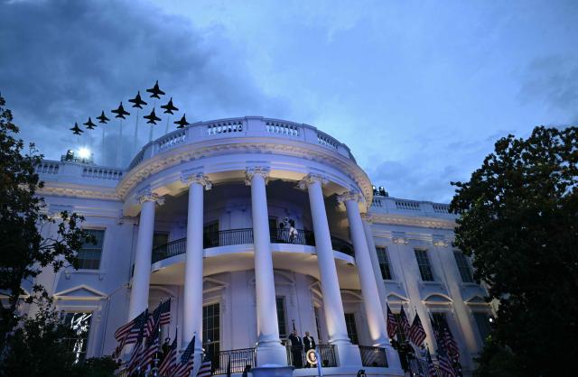 Aircrafts fly in formation over the White House as US President Donald Trump and President and CEO of Ultimate Fighting Championship Dana White listen to the National Anthem from the Blue Room Balcony ahead of the "UFC Freedom 250" mixed martial arts event on the South Lawn of the White House in Washington, DC, June 14, 2026. (Photo by Brendan SMIALOWSKI / AFP)