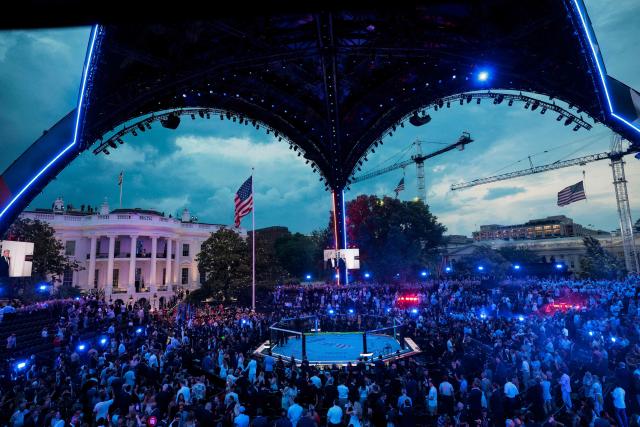 A screen shows US President Donald Trump walking with UFC CEO Dana White during the "UFC Freedom 250" mixed martial arts event on the South Lawn of the White House in Washington, DC, June 14, 2026. (Photo by Evan Vucci / POOL / AFP)