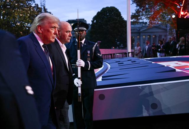 US President Donald Trump and President and CEO of Ultimate Fighting Championship Dana White arrive ahead of the "UFC Freedom 250" mixed martial arts event on the South Lawn of the White House in Washington, DC, June 14, 2026. (Photo by Brendan SMIALOWSKI / AFP)