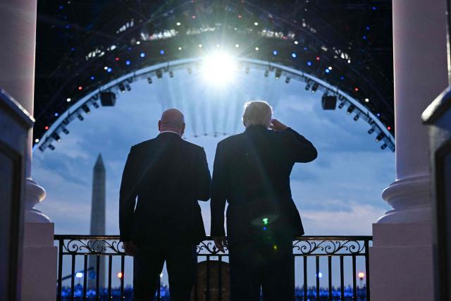 US President Donald Trump and UFC CEO Dana White stand on the Blue Room Balcony of the White House as US military jets perform a flyover during the "UFC Freedom 250" mixed martial arts event in Washington, DC, June 14, 2026. (Photo by SAUL LOEB / POOL / AFP)