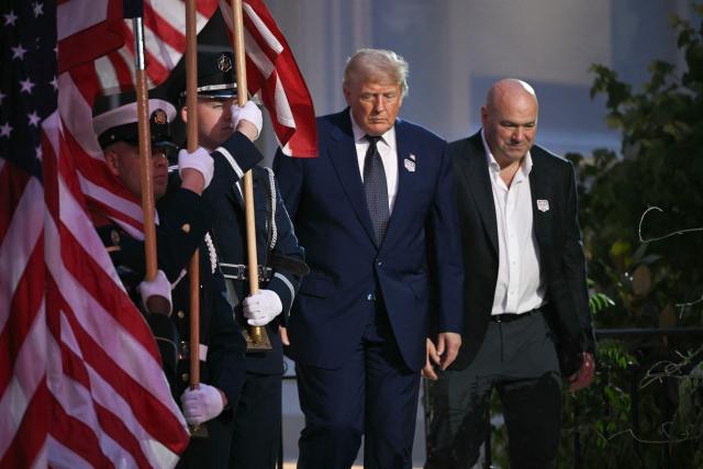 US President Donald Trump and President and CEO of Ultimate Fighting Championship Dana White arrive ahead of the "UFC Freedom 250" mixed martial arts event on the South Lawn of the White House in Washington, DC, June 14, 2026. (Photo by Brendan SMIALOWSKI / AFP)