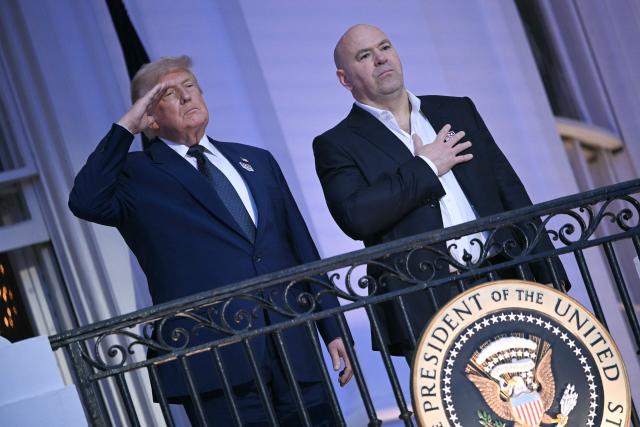 US President Donald Trump and President and CEO of Ultimate Fighting Championship Dana White listen to the National Anthem ahead of the "UFC Freedom 250" mixed martial arts event on the South Lawn of the White House in Washington, DC, June 14, 2026. (Photo by Brendan SMIALOWSKI / AFP)