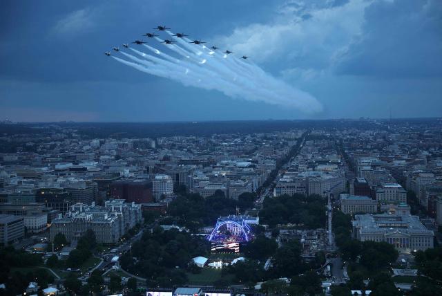 As seen from the Washington Monument, US Air Force Thunderbirds and the US Navy Blue Angels perform a flyover during the National Anthem at UFC Freedom 250 on the South Lawn of the White House on June 14, 2026 in Washington, DC. (Photo by Win McNamee / POOL / AFP)