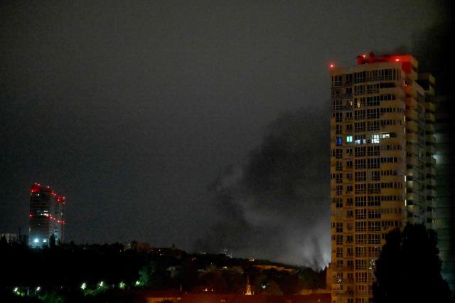 Smoke rises during a Russian missile strike on the Ukrainian capital Kyiv on June 15, 2026, amid the Russian invasion in Ukraine. A major missile attack struck Kyiv early on June 15, an AFP reporter witnessed, with projectiles intercepted in the sky and glowing debris falling onto the city. Ukrainian officials including the city's mayor Vitali Klitschko reported on Telegram that strikes hit various districts. (Photo by Sergei SUPINSKY / AFP)