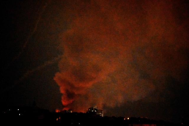 Smoke rises during a Russian missile strike on the Ukrainian capital Kyiv on June 15, 2026, amid the Russian invasion in Ukraine. A major missile attack struck Kyiv early on June 15, an AFP reporter witnessed, with projectiles intercepted in the sky and glowing debris falling onto the city. Ukrainian officials including the city's mayor Vitali Klitschko reported on Telegram that strikes hit various districts. (Photo by Sergei SUPINSKY / AFP)