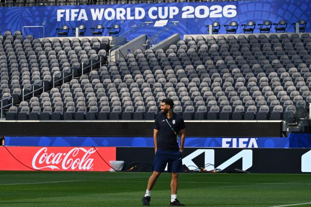 Iran's forward #20 Shahriyar Moghanloo walks around the pitch after the press conference at Los Angeles Stadium in Inglewood on June 14, 2026, on the eve of the 2026 World Cup football match between Iran and New Zealand. (Photo by Patrick T. FALLON / AFP)