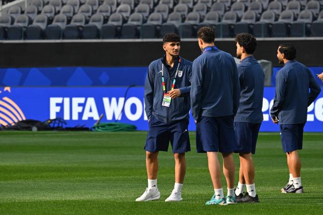 Iran's midfielder #26 Amirmohammad Razaghinia (L) walks around the pitch after the press conference at Los Angeles Stadium in Inglewood on June 14, 2026, on the eve of the 2026 World Cup football match between Iran and New Zealand. (Photo by Patrick T. FALLON / AFP)