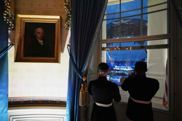 Two US Marines watch the UFC Freedom 250 event taking place on the South Lawn of the White House from the White House’s Blue Room, in Washington, DC, on June 14, 2026. (Photo by Jacquelyn Martin / POOL / AFP)
