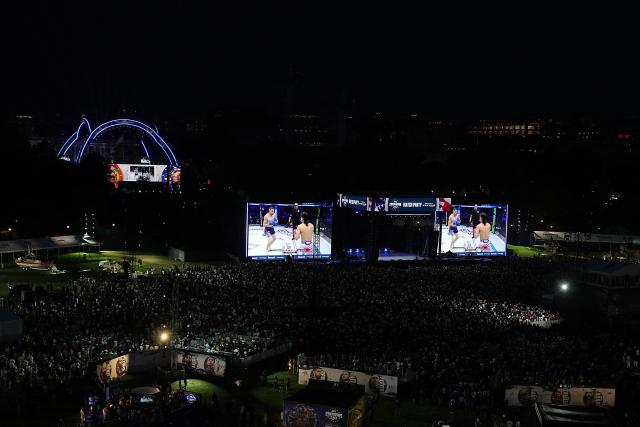 Fans watch the featherweight bout between Brazil's Diego Lopes and US's Steve Garcia on the big screen at the UFC Freedom 250 Fan Fest on The Ellipse during the UFC Freedom 250 fights being held on the South Lawn of the White House, in Washington, DC, on June 14, 2026. (Photo by Kevin Dietsch / POOL / AFP)