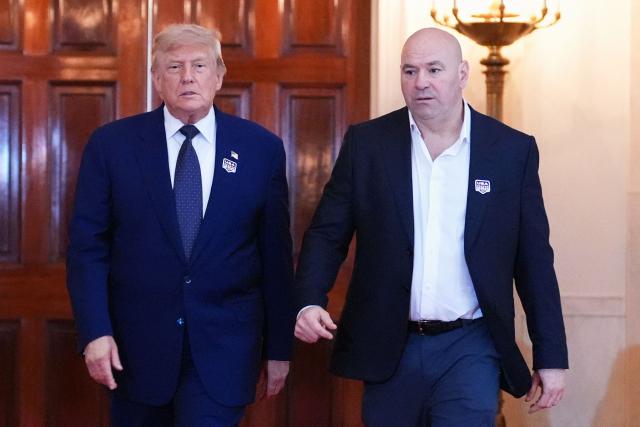 US President Donald Trump walks with UFC president and CEO Dana White through the Cross Hall of the White House before attending the UFC Freedom 250 fights on the South Lawn of the White House, in Washington, DC, on June 14, 2026. (Photo by Jacquelyn Martin / POOL / AFP)