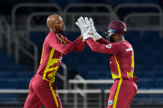 Roston Chase (L) of West Indies celebrates the dismissal of Kamil Mishara of Sri Lanka during the third Twenty20 (T20) international cricket match between West Indies and Sri Lanka at Sabina Park in Kingston, Jamaica, on June 14, 2026. (Photo by Randy Brooks / AFP)