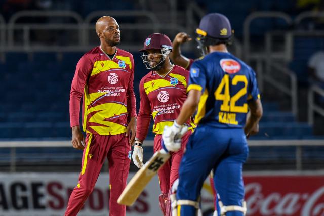 Roston Chase (L) and Shai Hope (2L) of West Indies celebrate the dismissal of Kamil Mishara (R) of Sri Lanka during the third Twenty20 (T20) international cricket match between West Indies and Sri Lanka at Sabina Park in Kingston, Jamaica, on June 14, 2026. (Photo by Randy Brooks / AFP)