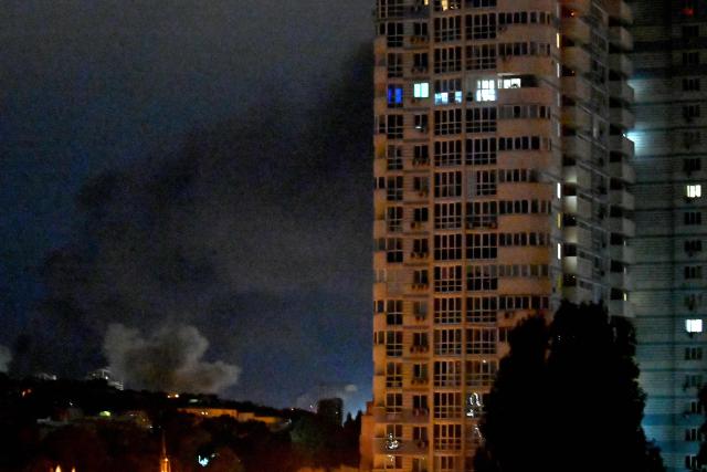 Smoke from an explosion is seen during a Russian missile strike on the Ukrainian capital of Kyiv on June 15, 2026, amid the Russian invasion in Ukraine. A major missile attack struck Kyiv early on June 15, an AFP reporter witnessed, with projectiles intercepted in the sky and glowing debris falling onto the city. Ukrainian officials including the city's mayor Vitali Klitschko reported on Telegram that strikes hit various districts. (Photo by Sergei SUPINSKY / AFP)