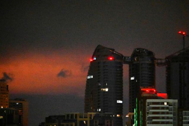 Glow from an explosion is seen during a Russian missile strike on the Ukrainian capital Kyiv on June 15, 2026, amid the Russian invasion in Ukraine. A major missile attack struck Kyiv early on June 15, an AFP reporter witnessed, with projectiles intercepted in the sky and glowing debris falling onto the city. Ukrainian officials including the city's mayor Vitali Klitschko reported on Telegram that strikes hit various districts. (Photo by Sergei SUPINSKY / AFP)